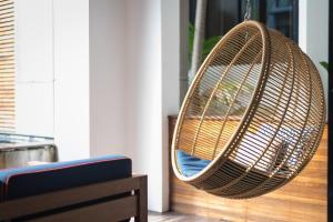 a rattan swing hanging from a porch at Idyllic Concept Resort in Ko Lipe
