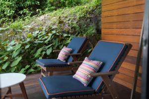two chairs with pillows sitting on a porch at Idyllic Concept Resort in Ko Lipe