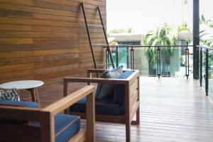 a balcony with a blue chair and a table at Idyllic Concept Resort in Ko Lipe