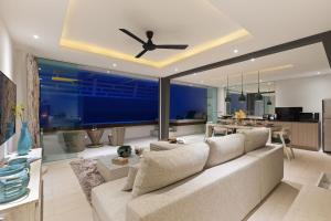Una sala de estar con un sofá y un ventilador de techo. en Villa Atlantis 6 - Deluxe 2BDR, Sea View, Private Pool, en Chaweng Noi Beach