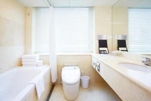 a bathroom with a tub and a toilet and a sink at Sejong Hotel Seoul Myeongdong in Seoul