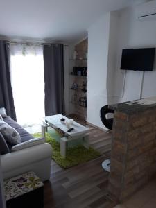 a living room with a couch and a table at Apartment Lavanda in Mali Lošinj