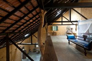 an attic room with a bunk bed and a wooden ceiling at The Kandy Samadhicentre in Kandy +104 photos