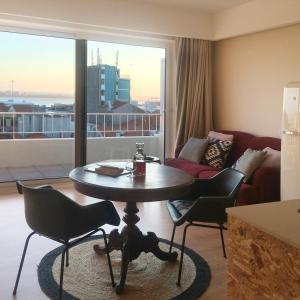 a living room with a table and chairs and a couch at Studio 177 in Matosinhos