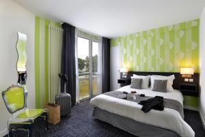 a hotel room with a bed and a window at Altos Hotel & Spa in Avranches