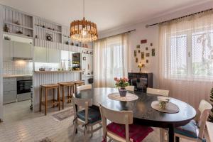 a kitchen and dining room with a table and chairs at Divna Apartments and Rooms in Račišće