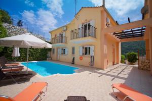 a villa with a swimming pool and a house at Gabriel Houses in Agia Effimia