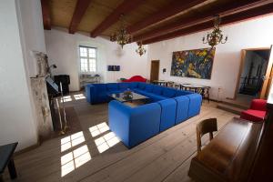 a living room with a blue couch and a table at Danhostel Vitskøl Kloster in Ranum