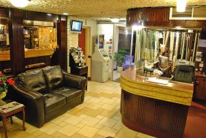 a store with a leather chair and a counter in a room at Chomedey Inn in Laval