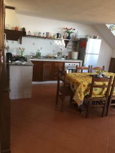 a kitchen with a table and chairs and a kitchen with a stove at La Nunziata in Positano +12 photos
