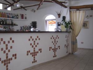 a kitchen with a counter and a window at Hotel Resort Nuraghe Arvu in Cala Gonone