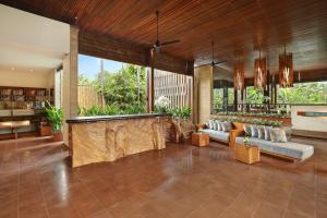 a large living room with couches and a table at The Elysian Boutique Villa Hotel in Seminyak