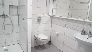 a white bathroom with a toilet and a sink at Kryształowa Józefów in Józefów +29 photos