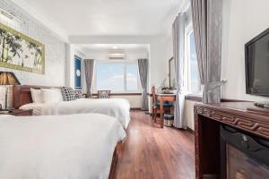 Postel nebo postele na pokoji v ubytování Prince II Hotel