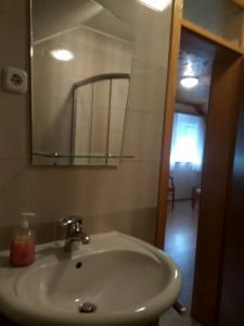 a bathroom with a sink and a mirror at Rooms Josip in Korenica