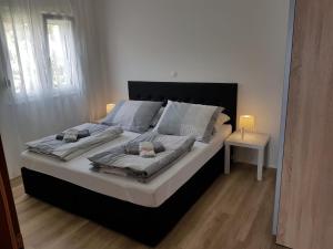 a bedroom with a large bed with white sheets and pillows at Villa Marina in Omiš
