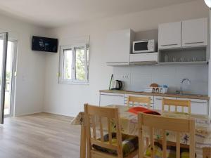 a kitchen and dining room with a table and chairs at Villa Marina in Omiš