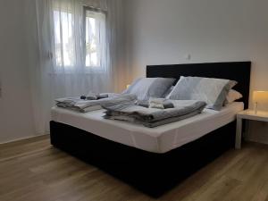 a large bed in a room with a window at Villa Marina in Omiš