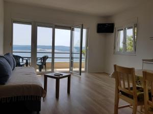 a living room with a bed and a view of the ocean at Villa Marina in Omiš +37 photos