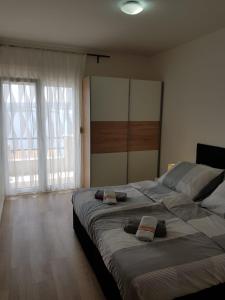 a bedroom with two beds and a large window at Villa Marina in Omiš