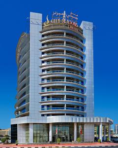 Un bâtiment avec un panneau en haut dans l'établissement City Seasons Hotel Dubai, à Dubaï