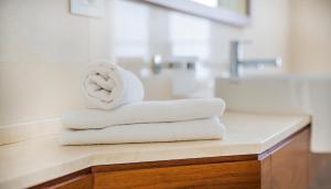 a stack of towels on a counter in a bathroom at Grand Hotel Terme Sirmione in Sirmione