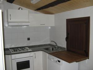 a small kitchen with a sink and a stove at Mas de Bruquet in Llimiana