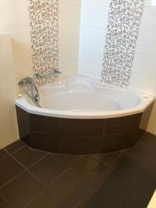 a bath tub in a bathroom with a shower curtain at Villa Evi in Ixia