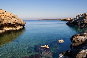 a view of the ocean between two rocky islands at Giorgi's Blue Apartments in Kalathas