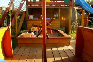 a playground with a slide and a play structure at Willa Arletta pokoje i strefa SPA in Jastrzębia Góra