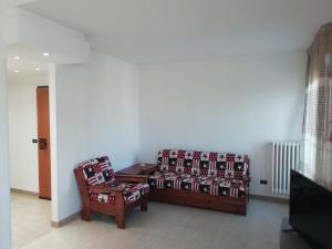 sala de estar con sofá y silla en Casa vacanze La rosa bianca en San Benedetto del Tronto