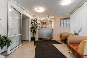 a living room with a couch and a table at Oazis Hotel in Pskov