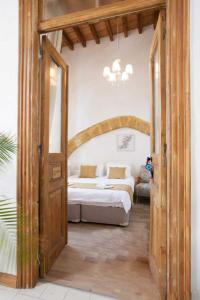 a bedroom with a bed and a large doorway at Pedieos Guest House in Lefkosa Turk