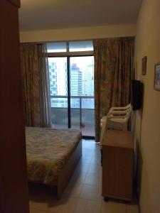 a hotel room with a bed and a window at Playa Club Argentina in Miramar