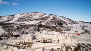 a large building in the snow on a mountain at Dr. Holms Hotel in Geilo