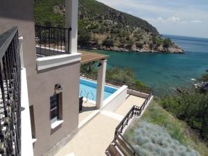 a house with a balcony with a view of the ocean at Thassos Grand Resort in Alyki