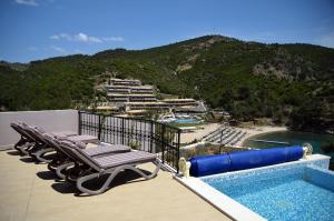 a group of chaise lounges on the deck of a resort at Thassos Grand Resort in Alyki
