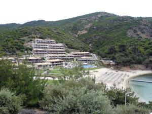 a resort on a hill next to a body of water at Thassos Grand Resort in Alyki
