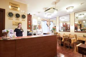 two women standing at a counter in a restaurant at Nevsky Contour in Saint Petersburg