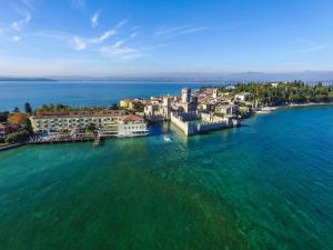 an aerial view of a town on the water at Grand Hotel Terme Sirmione in Sirmione