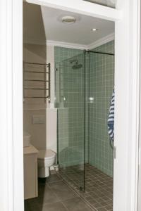 a bathroom with a toilet and a glass shower at Waterfront - 10 Spinniker Knysna Quays in Knysna