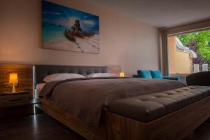 a bedroom with a large bed and a large window at Plaza Beach Holiday House in Prešov