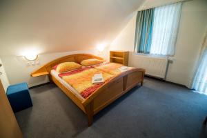 a bedroom with a large wooden bed in a room at Bed & Breakfast Hisa Resje in Bohinj