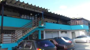 a parking lot with cars parked in front of a building at Pousada Costa Verde in Caraguatatuba