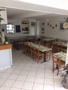 a dining room with tables and chairs in a restaurant at Relais Maximilien in Sully-sur-Loire