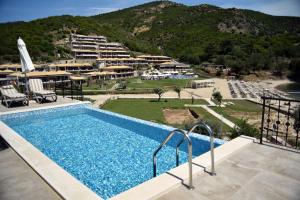 a swimming pool with a view of a resort at Thassos Grand Resort in Alyki