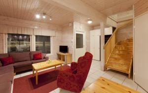 a living room with a couch and a table at Himosport Apartments in Jämsä