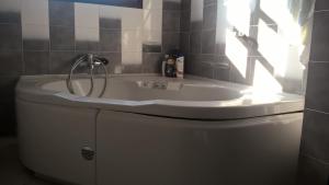 a bath tub with a sink on top of a toilet at Cavo Paradiso Villa in Asprovalta +24 photos