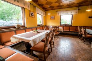 a dining room with a white table and chairs at Bed & Breakfast Hisa Resje in Bohinj