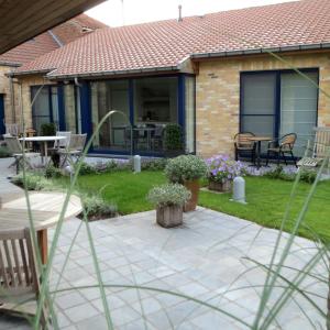 a house with a patio with a table and chairs at B&B Lievejan in Jabbeke